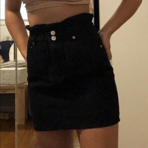 Black skirt with 2 buttons and zipper.